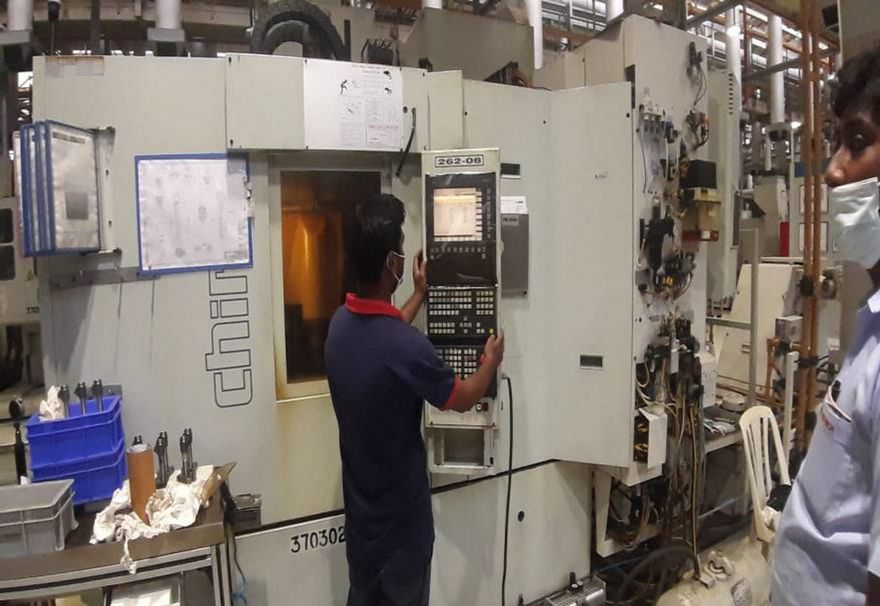 Yoganand technician operating a CNC machine